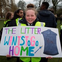 Litter Less Campaign 2018 23 Smiling girl holding a sign which reads "The Litter Wants To Go Home"