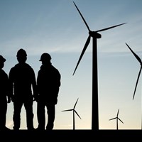 Men working on a wind turbine farm