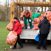 Litter Campaign 2018 - Photo 5 Adults loading orange recycling bags into the back of a van