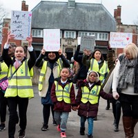 Litter Less Campaign 2018 13 Children marching across bridge in Abbey Park with campaign posters