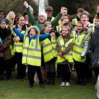 Litter Less Campaign 2018 16 Group of happy, excited children wearing high vis jackets and celebrating