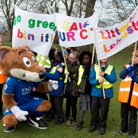 Litter Less Campaign 2018 25 Filbert Fox mascot crouched down next to children holding campaign banners