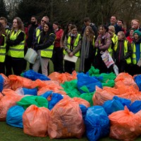 Litter Less Campaign 2018 26 Large group of volunteers in high-vis vests stood next to large pile of rubbish collected