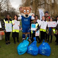 Litter Less Campaign 2018 31 Filbert Fox mascot stood behind collected rubbish, giving a thumbs up. Stood with children holding campaign posters