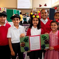 Eco-Schools celebration 37 Group of children holding up a presentation about ladybirds
