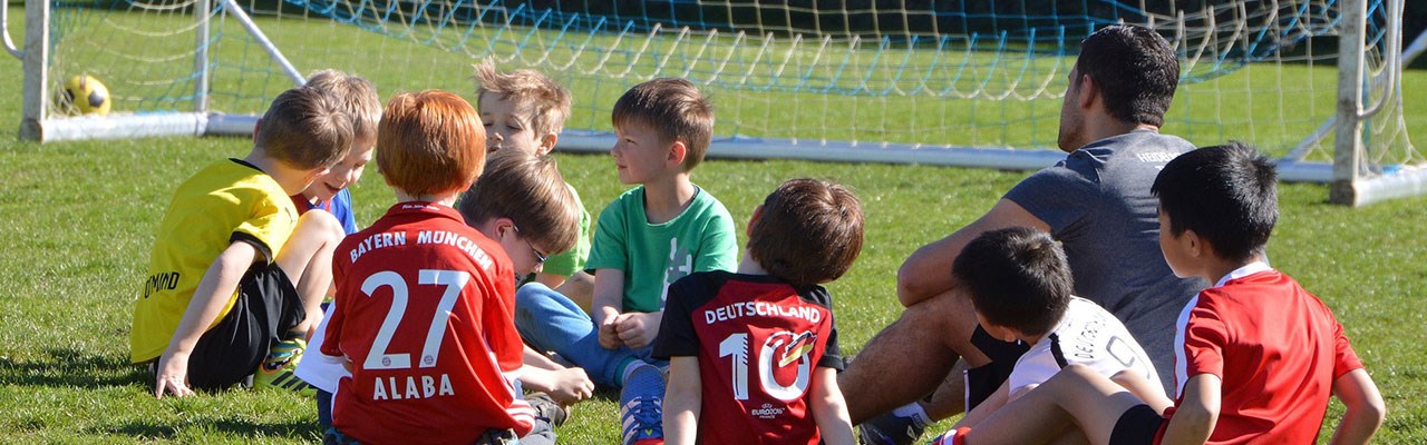 Children taking a rest from playing football