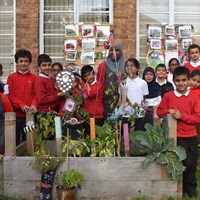 Grow Your Own Grub 2018 - 3 Children from Mayflower Primary School in their vegetable garden, holding up their winner's trophy