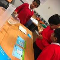 Rushey Mead 14 Children reading an activity card