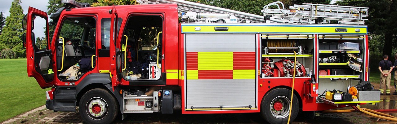 Firemen testing equipment on a fire engine