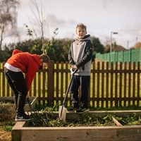 Two children digging with spades